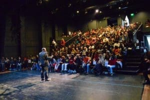 Man giving talk in front of crowd