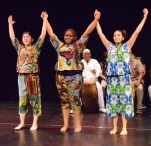 3 teenage girls in African dress