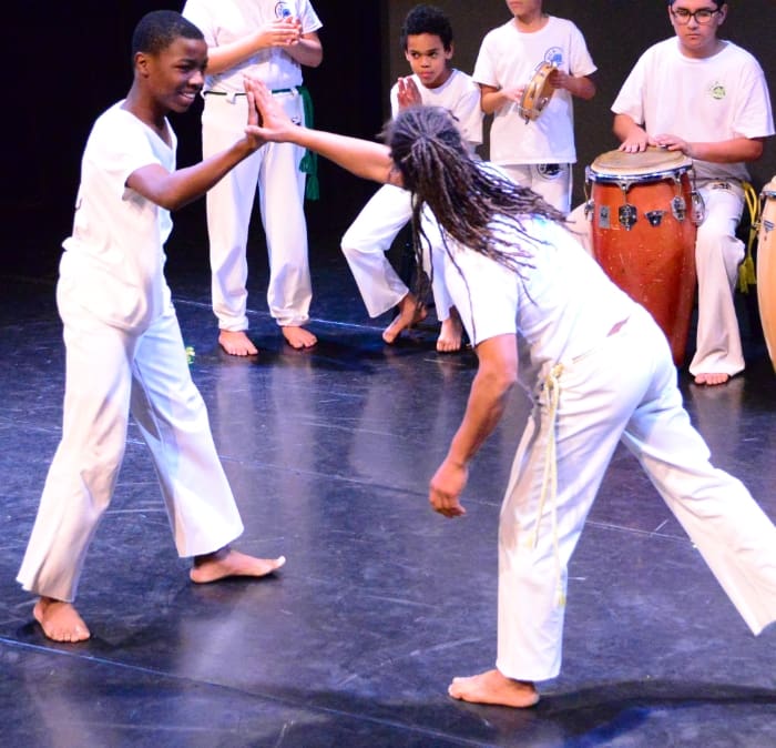 students and teacher on stage