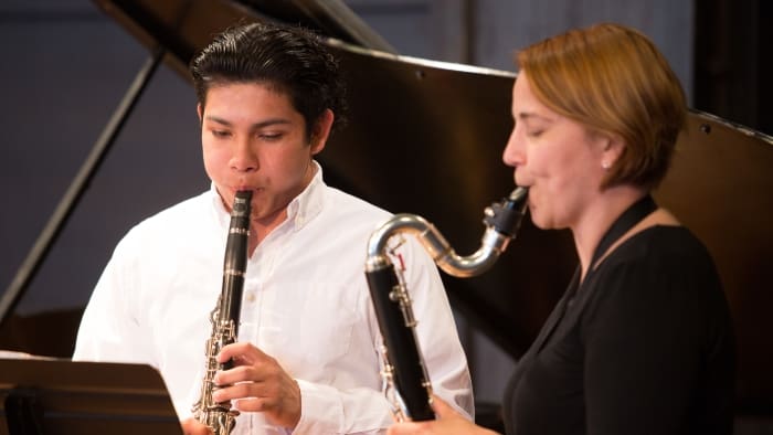 student and teacher in music class