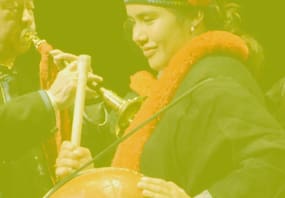 man playing flute and woman dancing