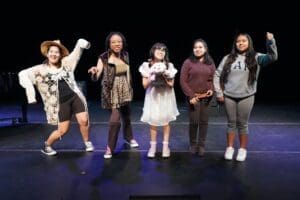 five students pose in a theater piece